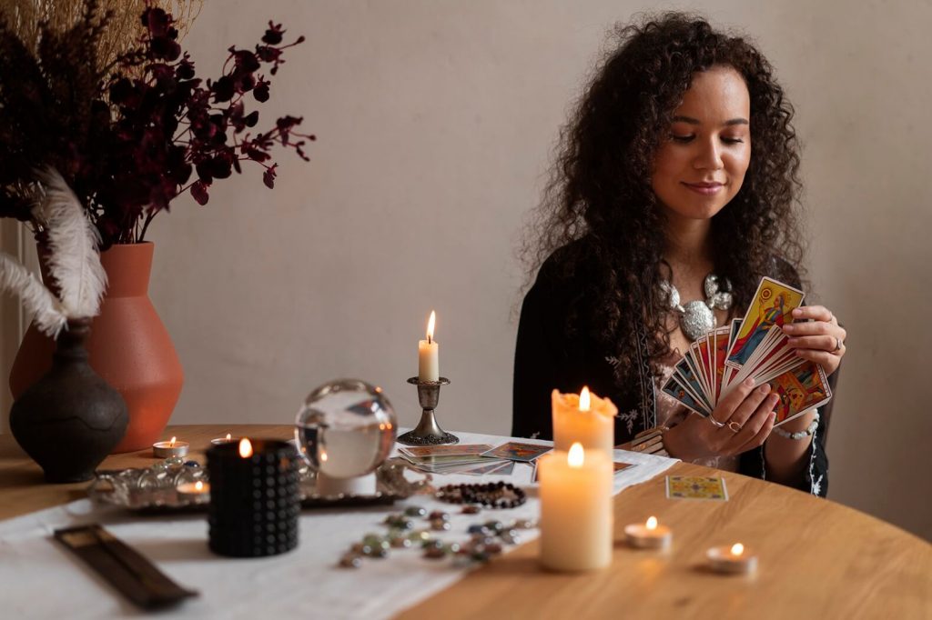 medium shot woman reading tarot table